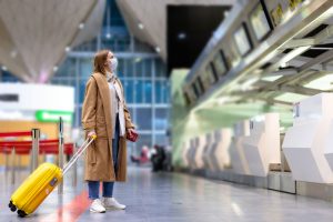 Woman,With,Luggage,Stands,At,Almost,Empty,Check-in,Counters,At